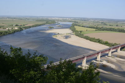 High angle view of river amidst trees against sky