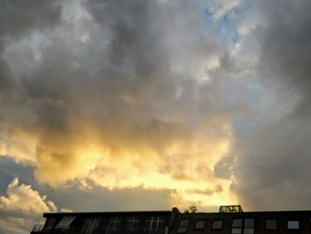 Low angle view of storm clouds over roof