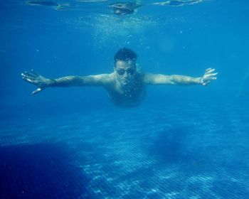 Man swimming in swimming pool