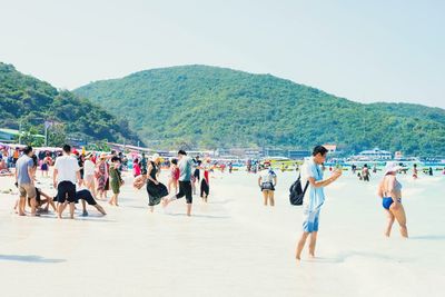 Group of people walking on beach