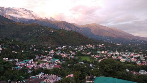 High angle view of townscape and mountains against sky