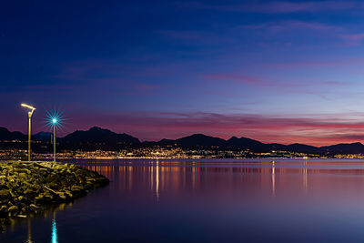 Scenic view of lake against sky at night