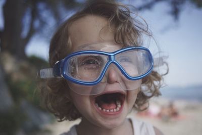 Close-up of toddler girl crying at beach