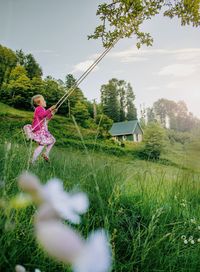Woman with flowers on field in background