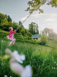 Girl swinging on field