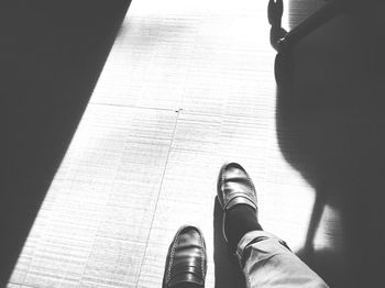 Low section of woman standing on tiled floor