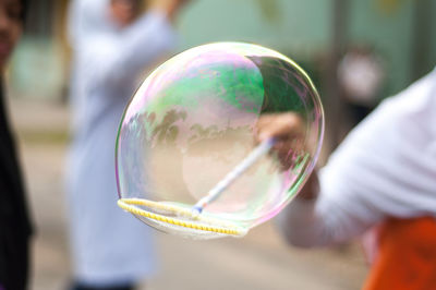 Close-up of woman holding bubbles