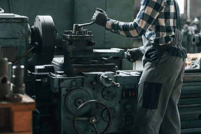 Rear view of man working in factory
