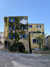 Exterior of old building against clear blue sky