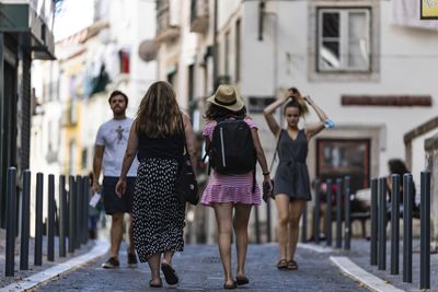 Rear view of women walking on street