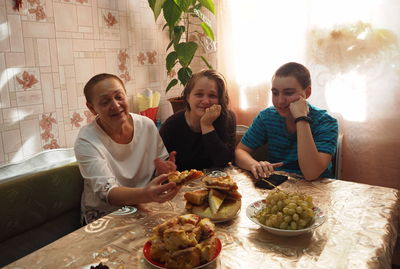 High angle view of friends sitting on table