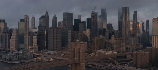 Modern buildings in city against sky,brooklyn bridge new york