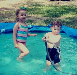 Full length of mother and daughter in swimming pool