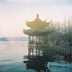 Gazebo in lake against sky