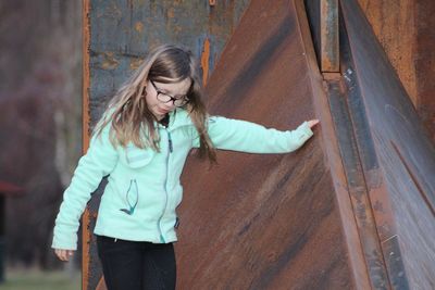 Girl walking against wall