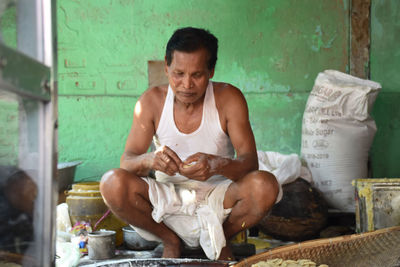 Full length of man sitting at workshop