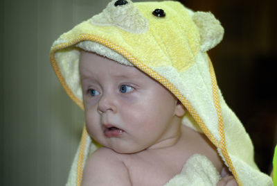 Close-up of cute baby boy looking away