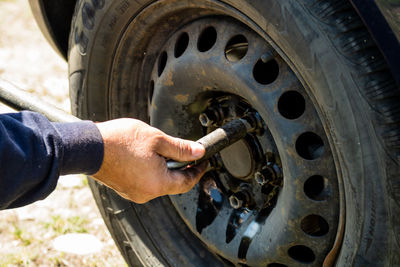 Cropped hand of man repairing car