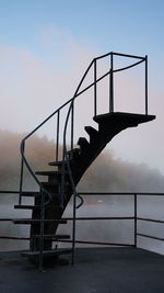 Metal staircase against sky