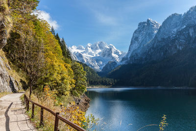 Scenic view of lake by mountains against sky