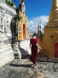 Full length of woman standing outside temple