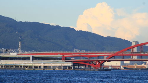 View of bridge over river against mountains