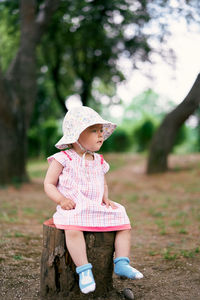 Full length of woman wearing hat against trees