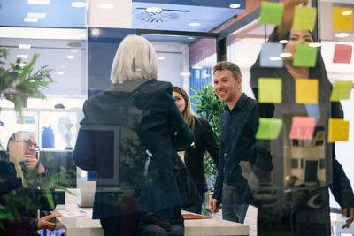 Rear view of business colleagues working on table