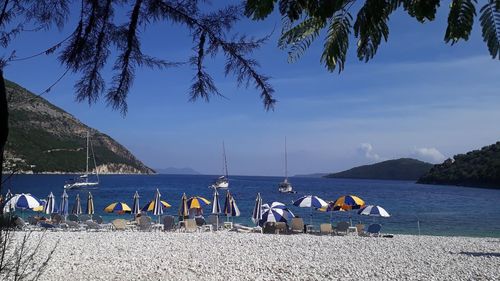 People on beach against sky