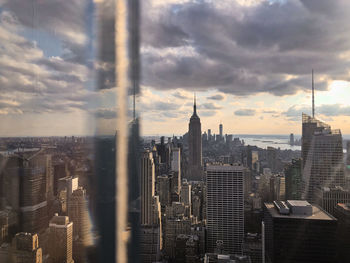 High angle view of buildings against cloudy sky