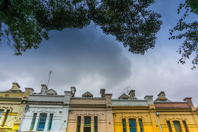 Low angle view of building against cloudy sky