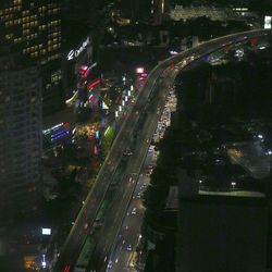 High angle view of light trails on highway in city at night