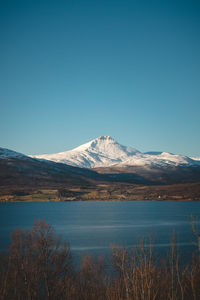 Wildlife of the northern part of norway, finnmark. snow-capped hills along with balsfjorden bay