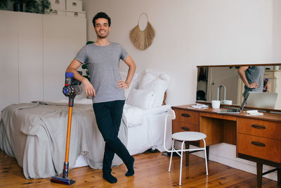 Full length of man standing on table at home