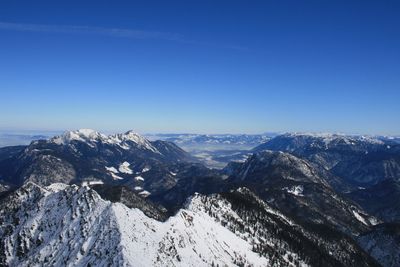 Scenic view of snowcapped mountains against clear blue sky