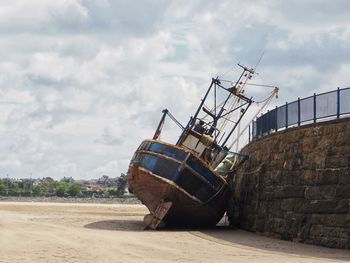 Boat on beach against sky