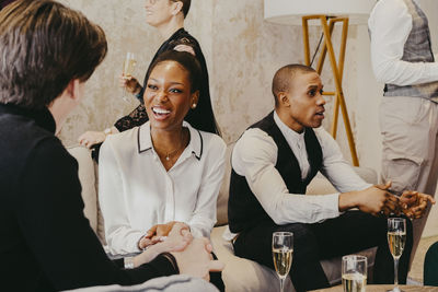 Male and female business colleagues communicating with each other during event at convention center