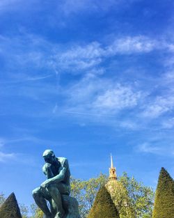 Low angle view of statue against blue sky