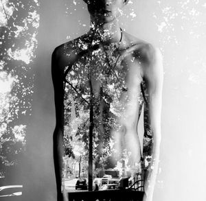 Double exposure of shirtless man and trees