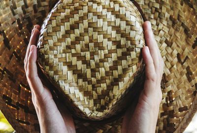 Cropped hands holding hat