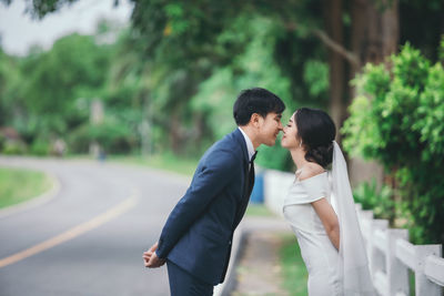 Rear view of couple walking on road