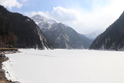 Scenic view of snow covered mountains against sky