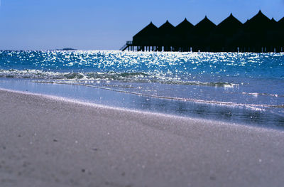 Scenic view of beach against blue sky