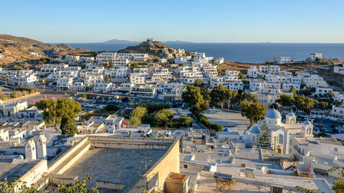 High angle view of townscape by sea against clear sky