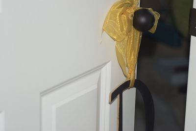 Close-up of electric lamp hanging on wall at home