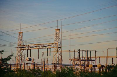 Electricity pylons against clear sky