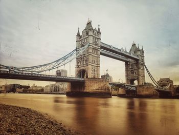 View of bridge over river against cloudy sky