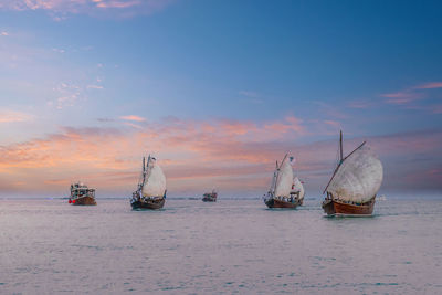 Beautiful cloudy evening at katara beach. traditional dhow boat at a katara beach