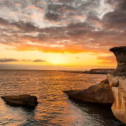 Scenic view of sea against cloudy sky