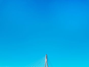 High section of cable-stayed bridge against clear blue sky